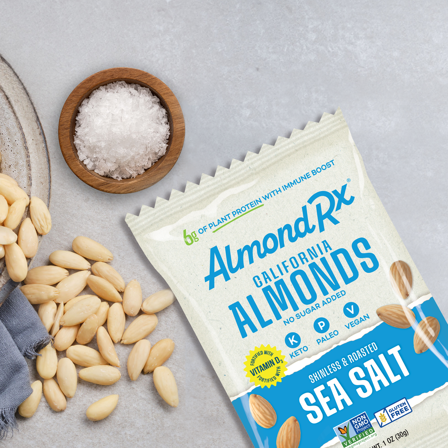 1 ounce package of almonds with bowl of skinless almonds and course sea salt.