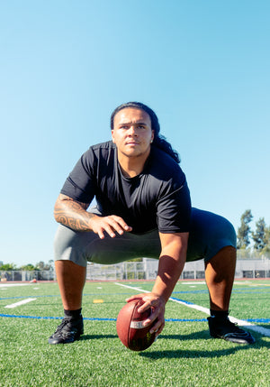 Charlie Pe'a-Shropshire, division 1 football player set with football.