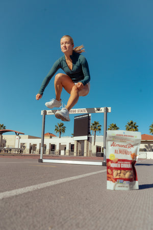 Karina Janik, star track athlete, flying over the hurdles.
