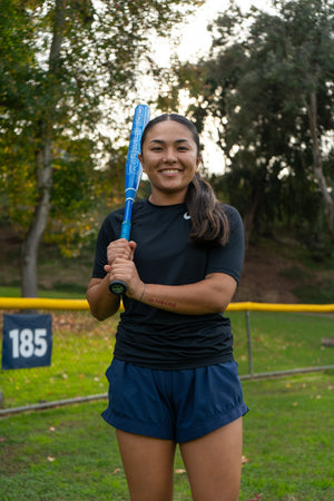 Kaylee Oh, star outfielder for SDSU, posing with softball bat.