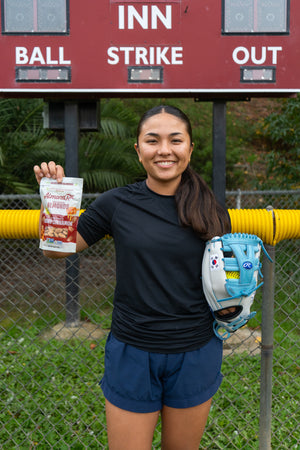 Kaylee Oh, star outfielder for SDSU, showing off her game day snacks.