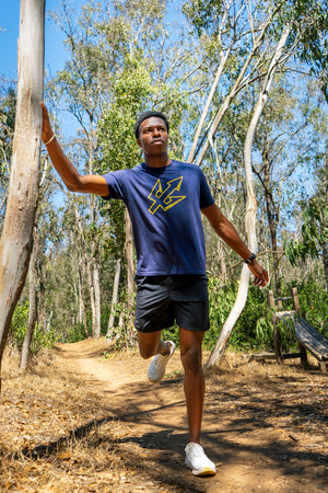Kenneth Tucker, UCSD track star, stretching in the woods before a run.
