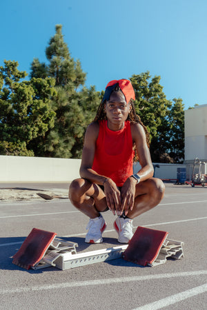 Takiyah Blue, NCAA Division 1 Track and Field star, posing by the starting blocks.
