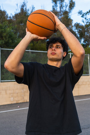 UCSD basketball player shooting baskets.