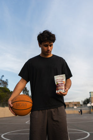 Basketball player checking out his favorite almond snack bag.